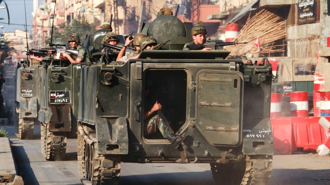 Lebanese army soldiers ride on their military vehicles after being deployed to tighten security following days of clashes between Sunni Muslims and Alawites in the port city of Tripoli, northern Lebanon May 21, 2013. (Reuters)
