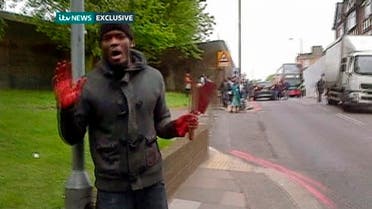 A man with bloodied hands and knives speaks to a camera as he appears in a still image from amateur video that shows the immediate aftermath of an attack in which a man was killed in southeast London May 22, 2013. (REUTERS)
