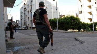 A Lebanese Sunni gunman holds a rifle in Al-Koubbeh, in Tripoli May 23, 2013.