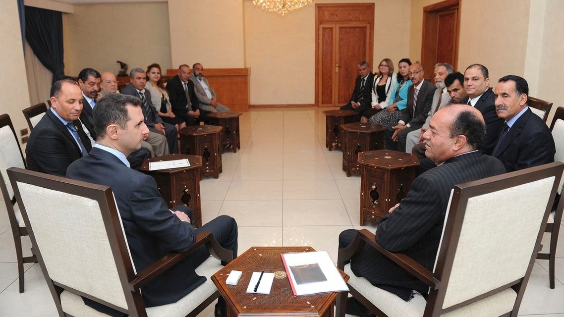 Syria's President Bashar al-Assad (L) speaks with Shukri Bin Suleiman Harmasi (R), secretary general of the Tunisian al-Thawabit (Immutable Principles) Party, and head of a Tunisian delegation consisting of representatives of Tunisian political parties, and economic and popular movements, during a meeting in Damascus in this handout photograph distributed by Syria's national news agency SANA on May 23, 2013. REUTERS