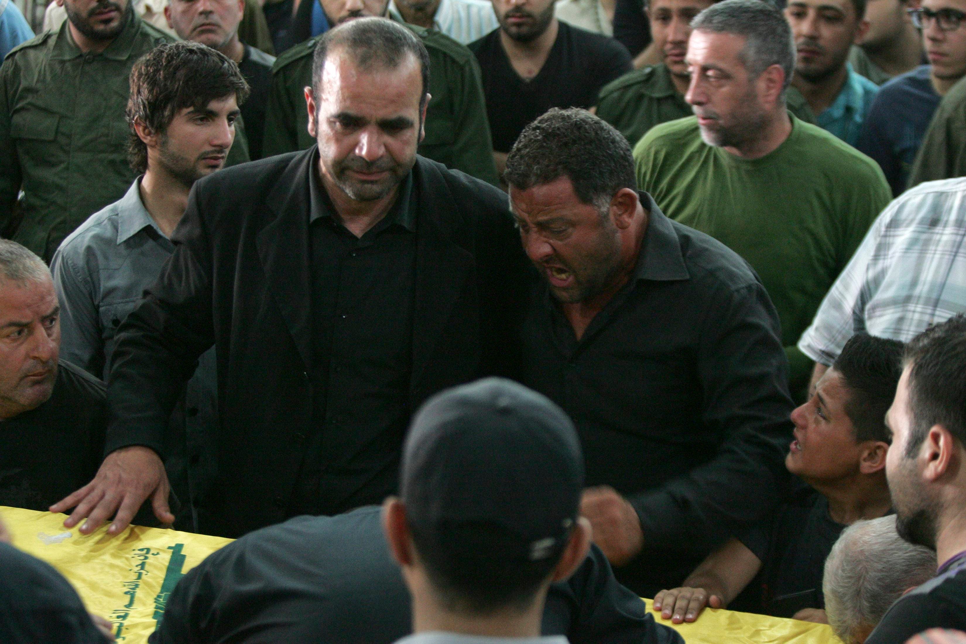 Relatives mourn during the funeral of Hezbollah member Hussein Ahmad Abu Hasan in Beirut’s suburbs May 21, 2013. (Reuters)