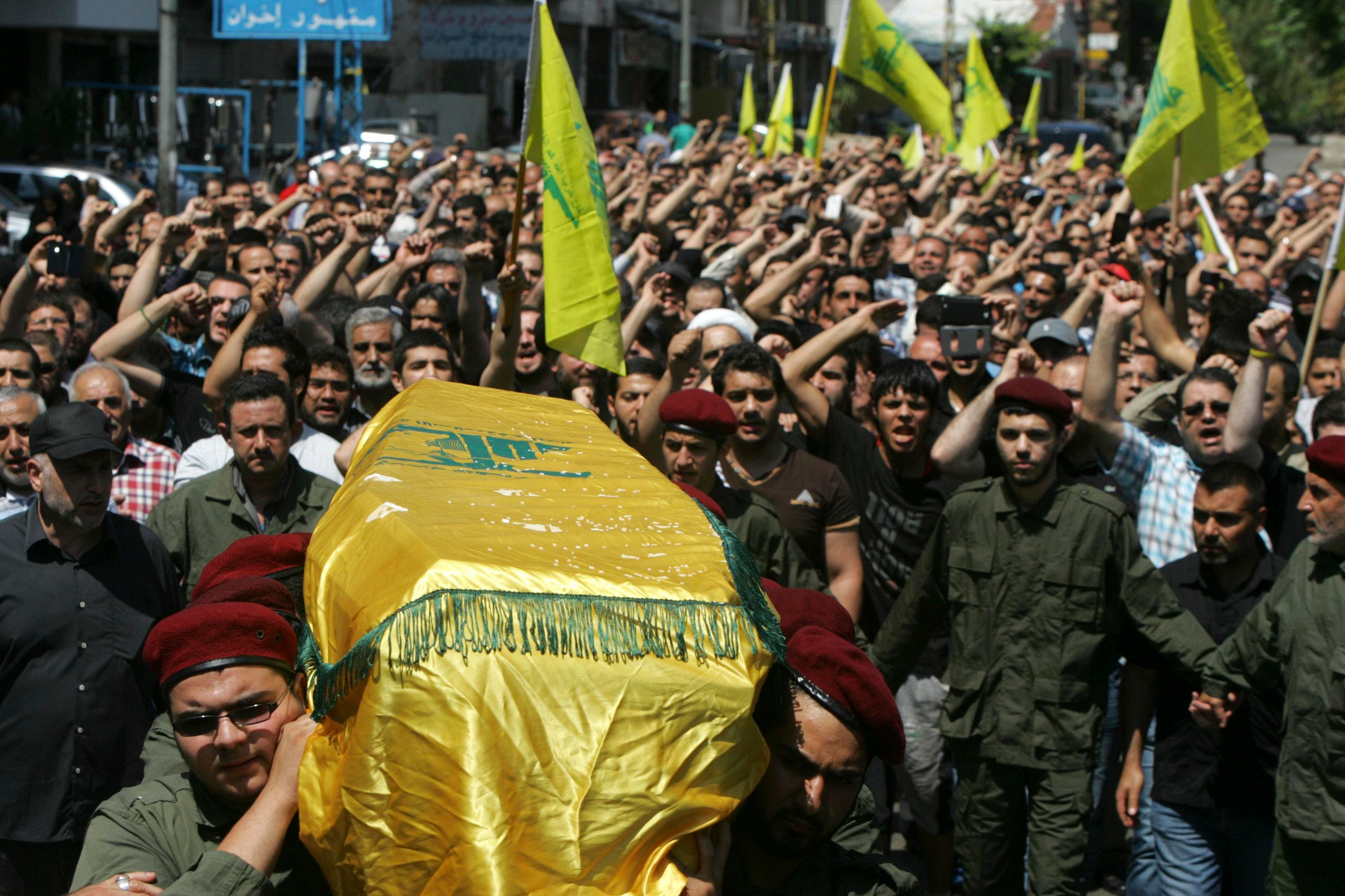 Supporters of Hezbollah and relatives of Hezbollah member Hussein Ahmad Abu Hasan carry his coffin during his funeral in Beirut’s suburbs May 21, 2013. (Reuters)