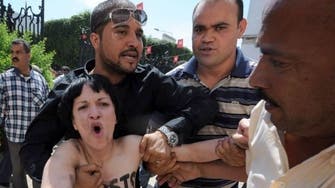 Little sympathy as topless protesters face Tunis trial 