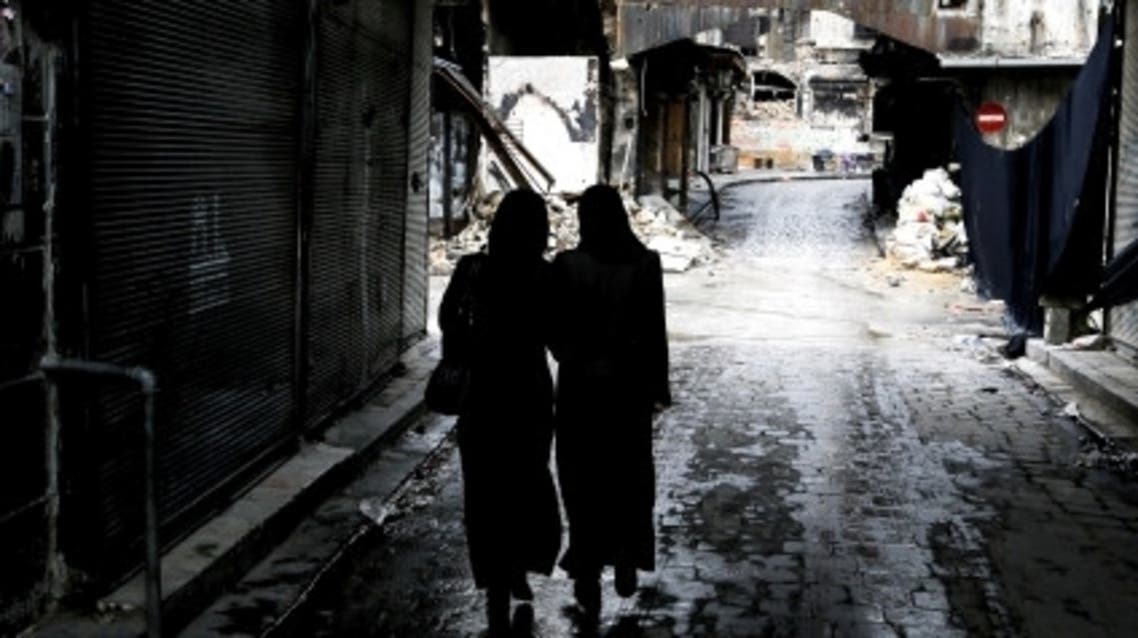 Syrian women walk down a souk shielded from the rain in Syria's northern city of Aleppo on November 11, 2012. (File Photo: AFP)
