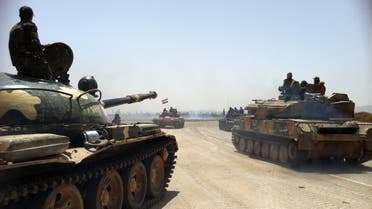 This photo taken by mobile phone on June 2, 2013 shows Syrian army tanks making their way to the Dabaa military airfield, north of the Syrian city of Qusayr. (AFP)
