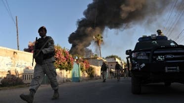 Smoke rises from the ICRC's compound in Jalalabad, eastern Afghanistan, following Wednesday's attack. (AFP)