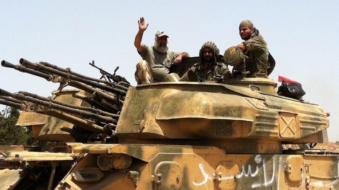 This photo taken by mobile phone on June 2, 2013 shows Syrian army tanks making their way to the Dabaa military airfield, north of the Syrian city of Qusayr. (AFP)