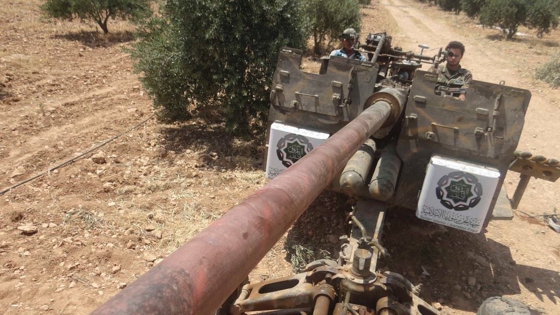 Free Syrian Army fighters from The Syrian Islamic Liberation Front are seen sitting on an artillery in Hama, June 2, 2013. (REUTERS)