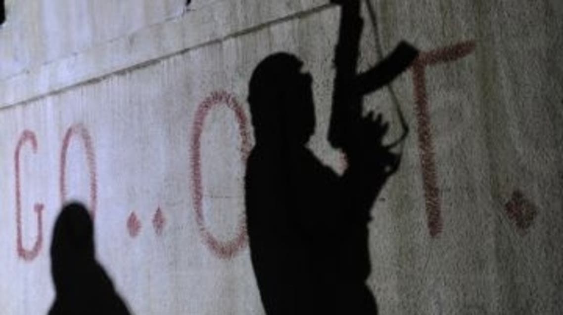 The shadows of armed Free Syrian Army rebels are seen on a wall at the entrance to the north Syrian city of Binnish on Feb. 15, 2012. (Bulent Kilic /AFP/Getty Images)