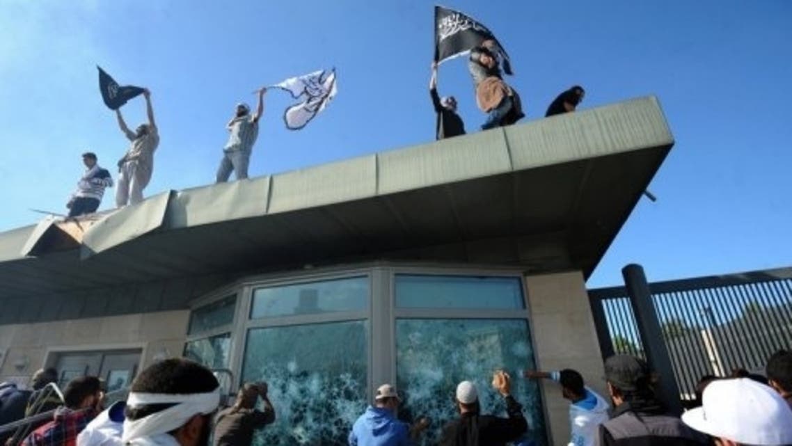Tunisian protesters break the windows of US embassy in Tunis during a protest on September 14, 2012. (AFP)