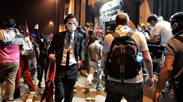 TOPSHOTSA man leaves from clash site between Taksim and Besiktas in Istanbul on June 4, 2013 during a demonstration against the demolition of the park.  (AFP)