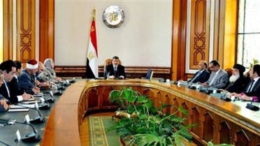 In this image released by the Egyptian Presidency, Egyptian President Mohammed Morsi, center, meets with politicians at the Presidential Palace in Cairo, Egypt, Monday, June 3, 2013.  (Photo courtesy: AP)