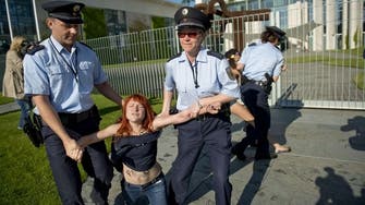 Topless protesters rally outside Merkel office