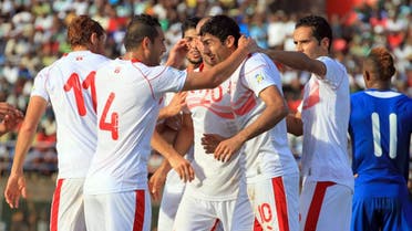 Tunisian players congratulate their teammate Oussama Darragi (2nd R) on June 8, 2013 after he scored against Serra Leone during a 2014 World Cup qualifying football match at the Freetown stadium. (AFP)