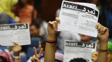 Protesters opposing Egyptian President Mohammad Mursi hold up documents from the "Tamarod" campaign during a news conference at their headquarters in Cairo May 29, 2013. (Reuters)