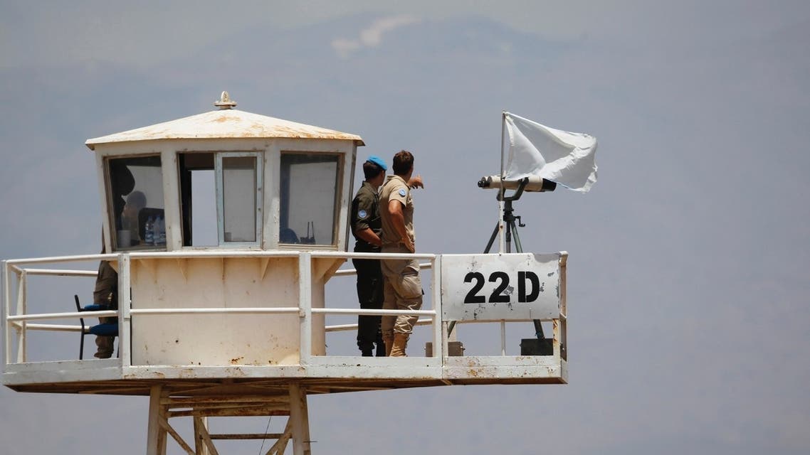 U.N.) peacekeeping soldiers from Austria stand on an observation tower near the Quneitra border crossing between Israel and Syria REUTERS