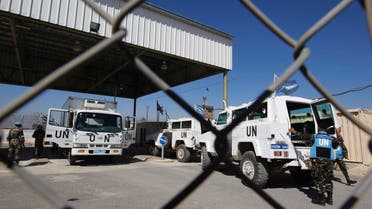 U.N. peacekeeping soldiers stand near vehicles at the Quneitra border crossing between Israel and Syria, in the Israeli-occupied Golan Heights June 11, 2013.