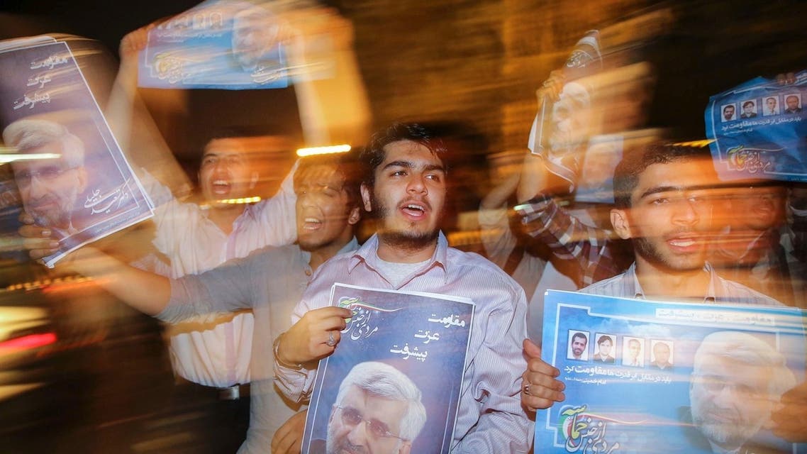 Supporters carry campaign posters for Iranian presidential candidate Saeed Jalili on the streets of Tehran June 12, 2013.