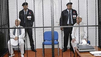 Qaddafi officials acquitted but stay behind bars