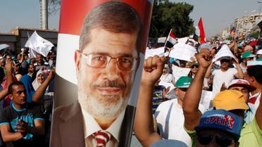Supporters of Egyptian President Mursi shout slogans during protest around Raba El-Adwyia mosque square in Cairo June 21, 2013. (Reuters)