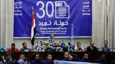 Members of the "Tamarod" movement hold a news conference at their headquarters in Cairo