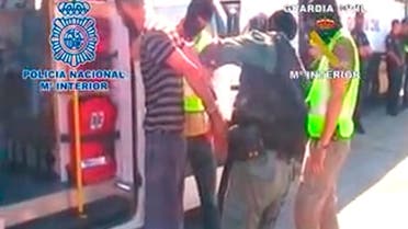 An image grab taken from a handout video released on June 22, 2013 by the Spanish Interior Ministry shows members of the Spanish security forces detaining one of the eight unidentified suspected terrorists arrested in Ceuta on June 21. AFP