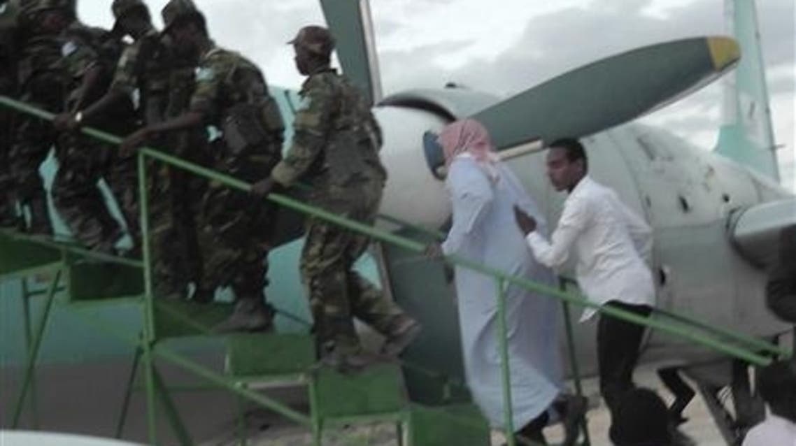 Sheikh Hassan Dahir Aweys (2nd R), one of Somalia's most prominent Islamist rebel commanders, who was arrested on Wednesday, is escorted at Adado airstrip June 29, 2013, to be transferred to capital Mogadishu. (Reuters)
