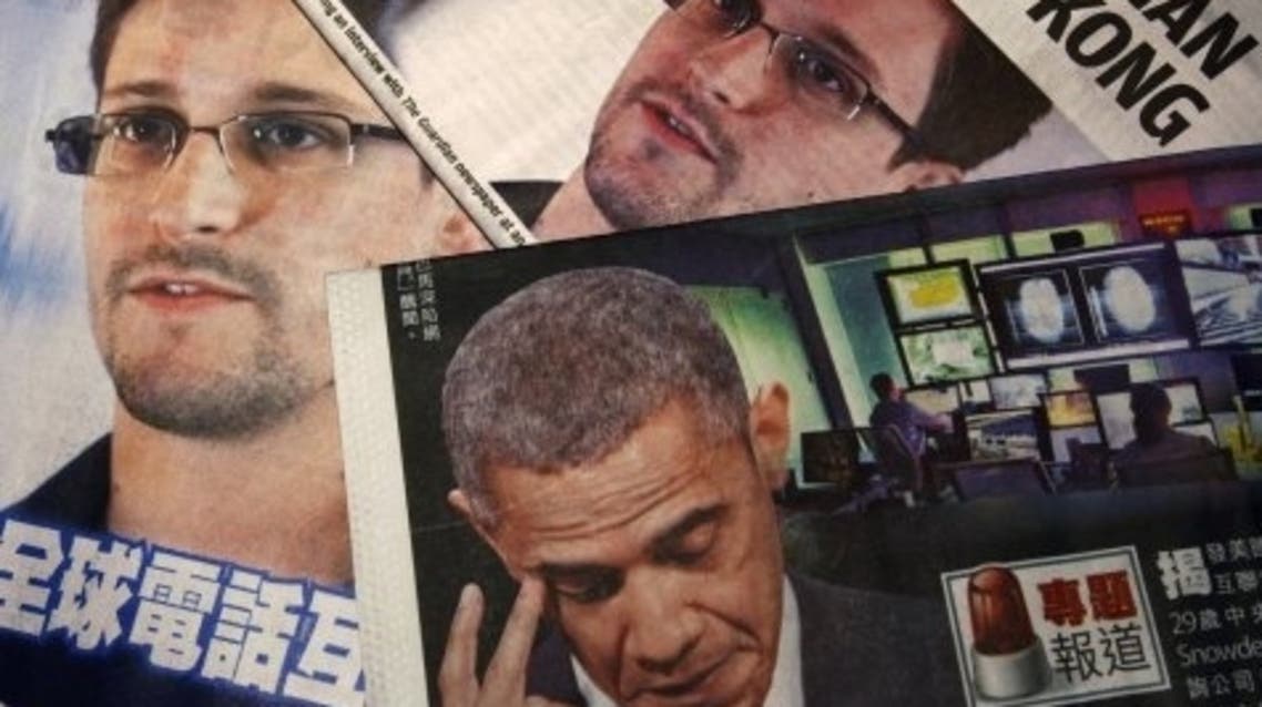 Photos of Edward Snowden and U.S. President Barack Obama are printed on the front pages of local English and Chinese newspapers. (Reuters)
