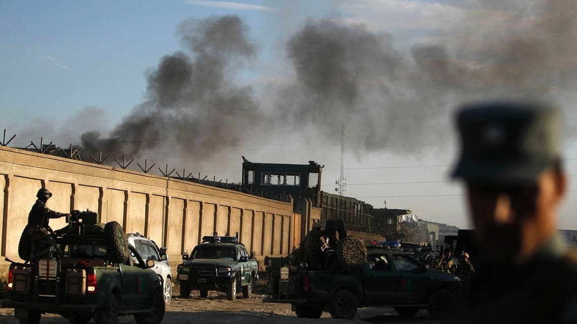 Afghan security forces keep watch as smoke rises from the site of an attack in Kabul, July 2, 2013.