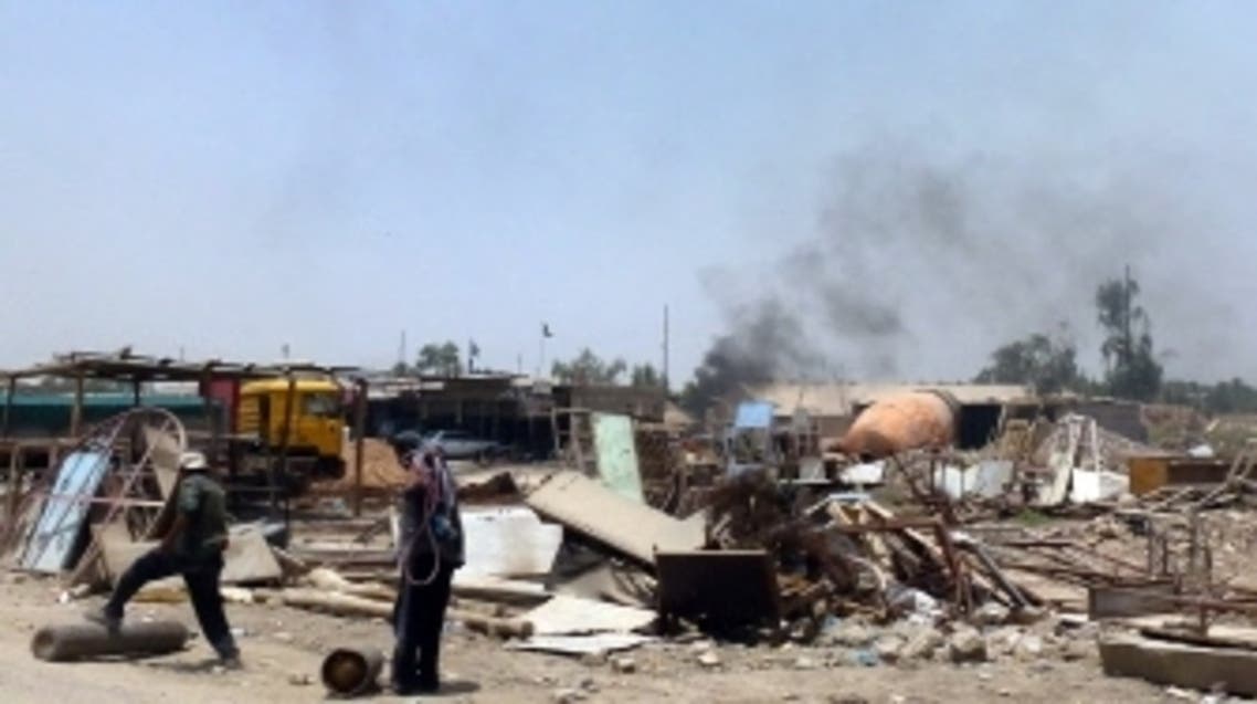 Black smoke rises at the site of a detonated improvised explosive device in the area of Nahrawan, southeast of Baghdad, near the children's playground on July 3, 2013. A bombing on Baghdad's southern outskirts killed seven people, the latest in a three-day wave of bloodshed targeting Shiite Muslims that has left 113 dead amid fears Iraq is slipping back into all-out sectarian war. AFP PHOTO