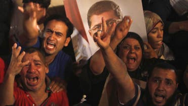 Supporters of Egypt's President Mohamed Mursi react after the Egyptian army's statement was read out on state TV, at the Raba El-Adwyia mosque square in Cairo July 3, 2013. Reuters