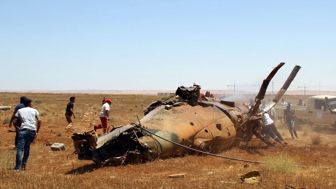 Libyan emergency personnel inspect the wreckage of a military helicopter that crashed during an airshow in the eastern city of Benghazi on July 4, 2013. AFP