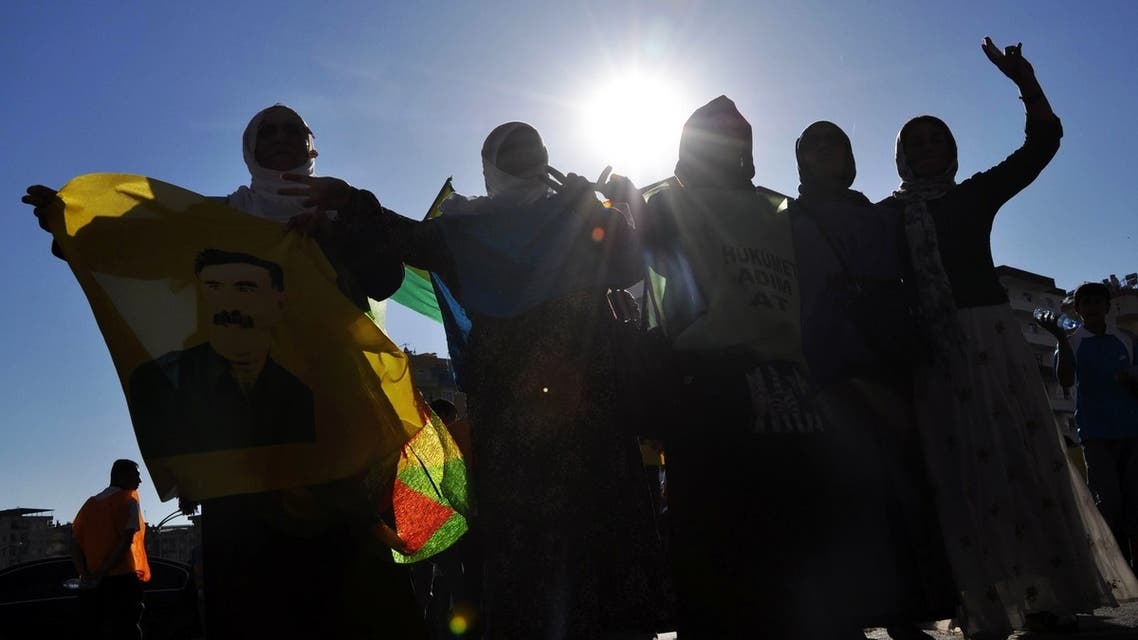 Kurds dance with a picture of PKK (Kurdistan Workers Party) jailed leader Abdullah Ocalan during a protest on June 30, 2013, in Diyarbakir. AFP