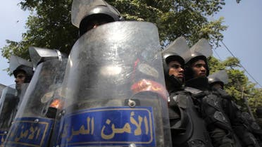 Riot police stand with their shields as members of the Muslim Brotherhood and supporters of ousted Egyptian President Mohamed Mursi protest in front of Egypt's Constitutional Court. (Reuters)