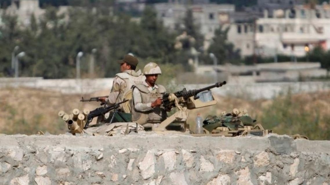 Egyptian soldiers stand guard on at the border between Egypt and southern Gaza Strip, July 5, 2013. Reuters
