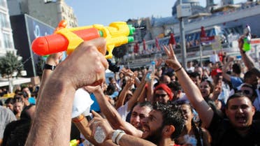 Demonstrators shout slogans as they spray water on each other in central Istanbul July 6, 2013. (Reuters)