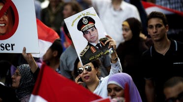 An Egyptian woman holds a portrait of Military Chief General Abdel fattah al-Sissi during a march towards Egypt's landmark Tahrir square against deposed President Mohammed Morsi on July 7, 2013 in Cairo, Egypt. (AFP)
