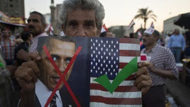 An Egyptian man holds an image of US President Barack Obama as they rally in Cairo's Tahrir Square, on July 7, 2013. (File photo: AFP)