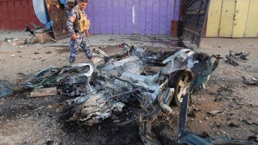 An Iraqi policeman inspects the site of a car bomb attack in Kirkuk, 250 km north of Baghdad, July 11, 2013. (Reuters)