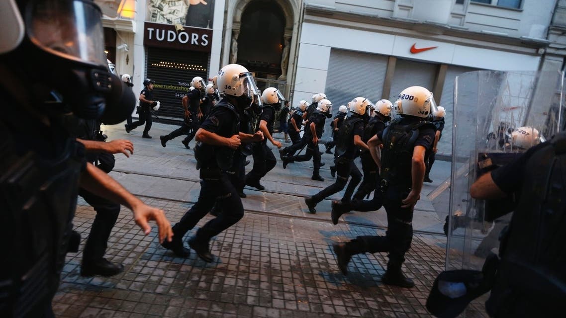 Riot police officers run after demonstrators on Istiklal Street in central Istanbul July 13, 2013. (Reuters)