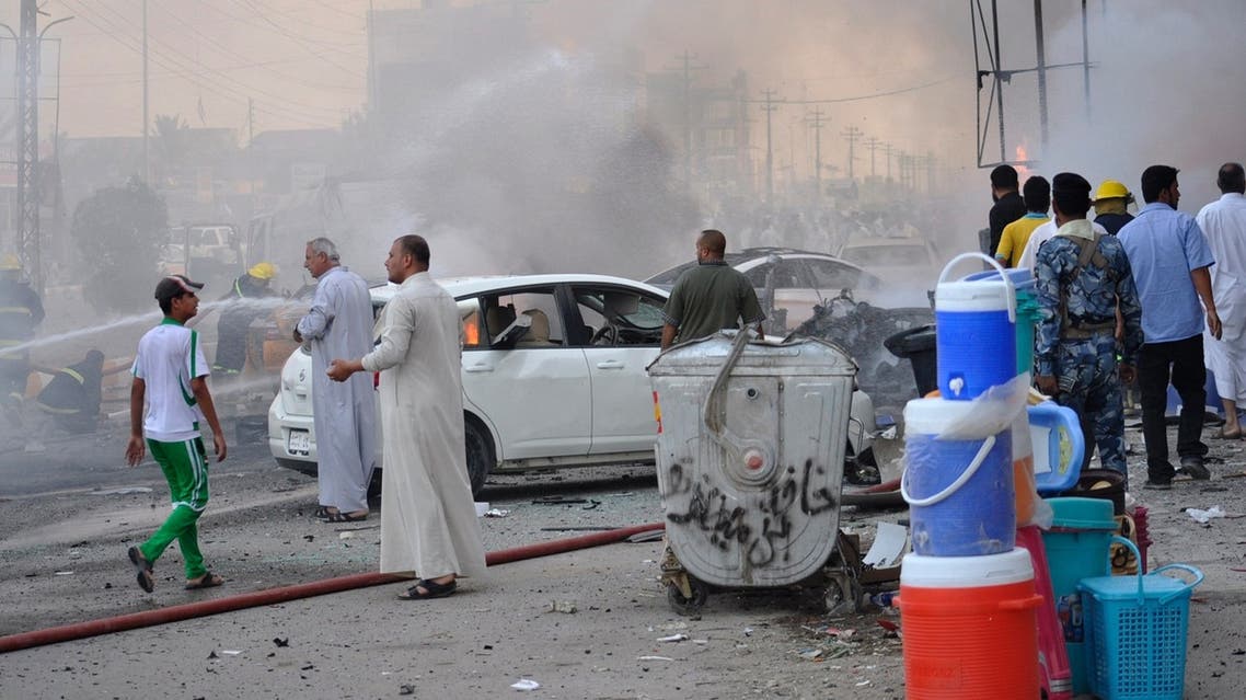 Civilians gather after two car bombs went off in Nassiriya city, 300 km (185 miles) southeast of Baghdad, July 14, 2013. (Reuters)