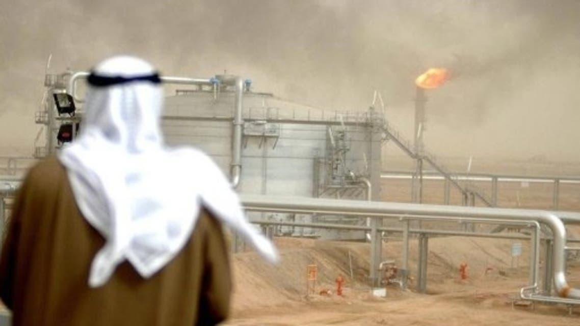 An employee of the Kuwait Oil Company (KOC) looks at the al-Rawdatain refinery. (File Photo: AFP)