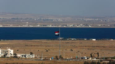 A Syrian flag flutters on the Syrian side of the ceasefire line between Israel and Syria near the Quneitra border crossing on the Israeli-occupied Golan Heights July 3, 2013. (Reuters)