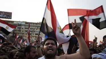 Muslim Brotherhood members and supporters of deposed president Mohammed Morsi shout slogans waving national flags during a rally outside Rabaa al-Adawiya mosque on July 15, 2013 in Cairo, Egypt. (Reuters)