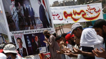 Members of the Muslim Brotherhood and supporters of deposed Egyptian President Mohammad Mursi perform afternoon prayers in Cairo at the Rabaa Adawiya square, where they are camping. (Reuters)