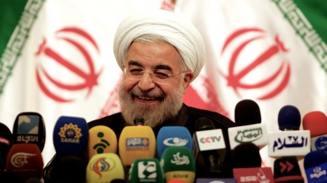 Iranian President-elect Hassan Rowhani smiles during a press conference in Tehran on June 17, 2013.
