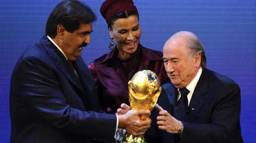 FIFA president Sepp Blatter hands over the World Cup trophy to the emir of Qatar Sheikh Hamad bin Khalifa al-Thani and his wife Chair in Zurich. (File Photo: AFP)