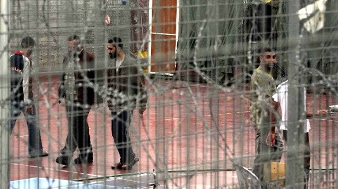 Palestinian prisoners walk 06 November 2005 at the yard of Megiddo prison. (AFP Photo / Menahem Kahana)