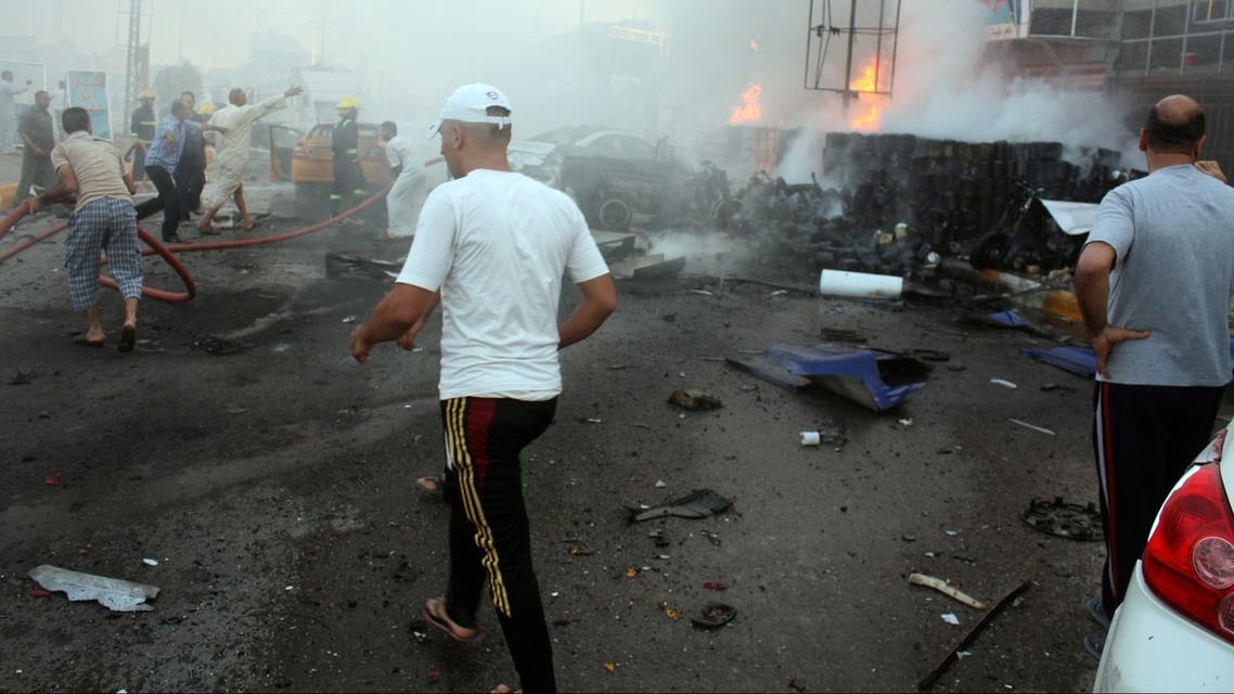 Iraqis rush to the scene of an explosion in the city of Nasiriyah, south of the Iraqi capital Baghdad, on July 15, 2013. (AFP)