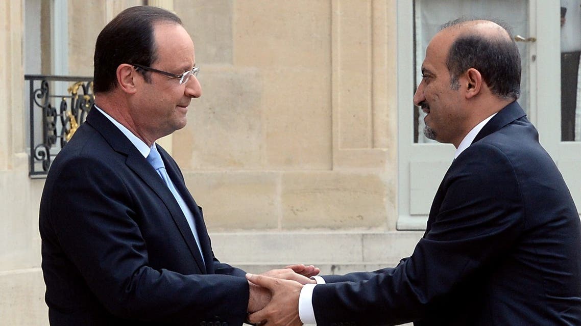 Syria's new opposition leader Ahmad Jarba (R) shakes hand with France President François Hollande as he arrives for a meeting at the Elysee presidential palace on July 24, 2013 in Paris. (AFP)